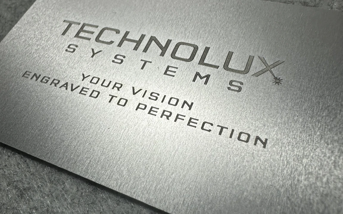 Laser engraved metallic business card with Technolux Systems branding